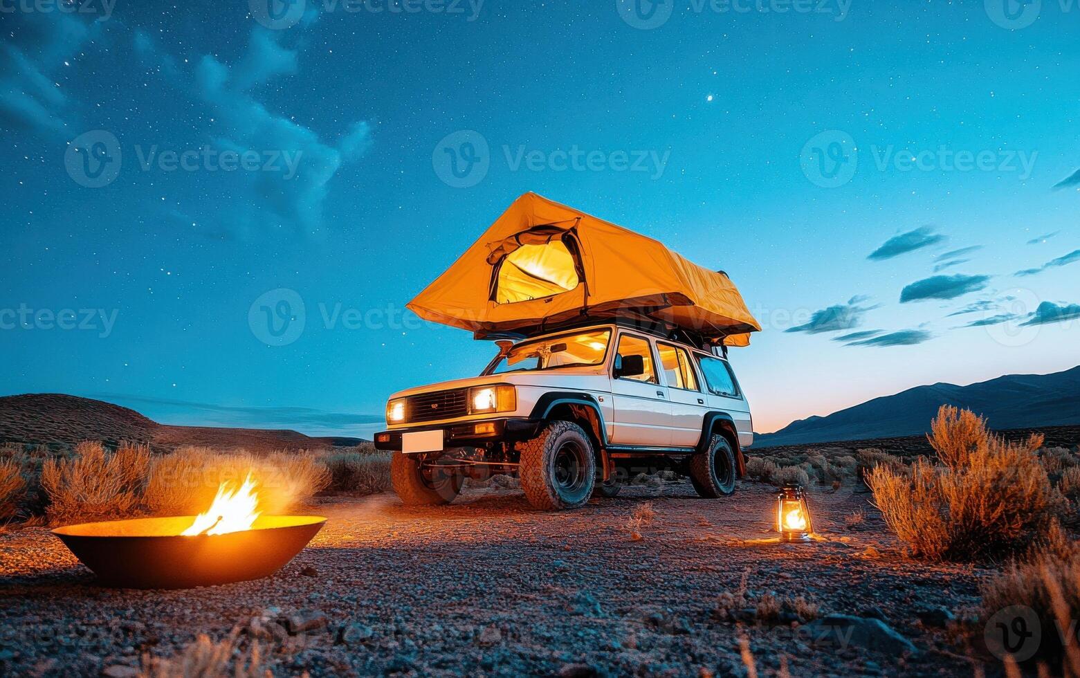 Camping under a starry night sky with an off-road vehicle and a cozy fire in the wilderness photo