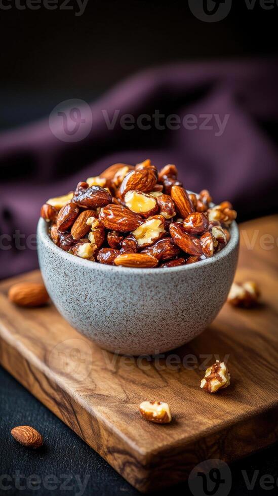 Delicious assortment of roasted nuts presented in a rustic bowl on a wooden board in a cozy setting photo
