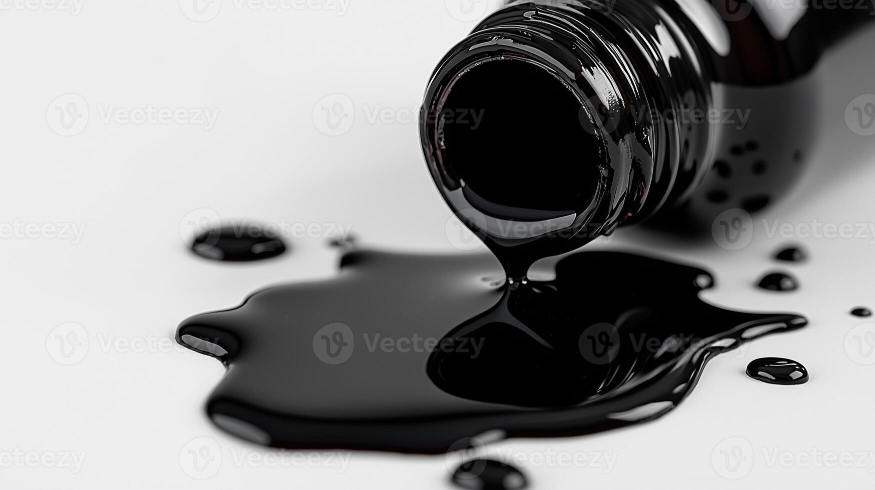 Black paint spilled from bottle on white surface photo