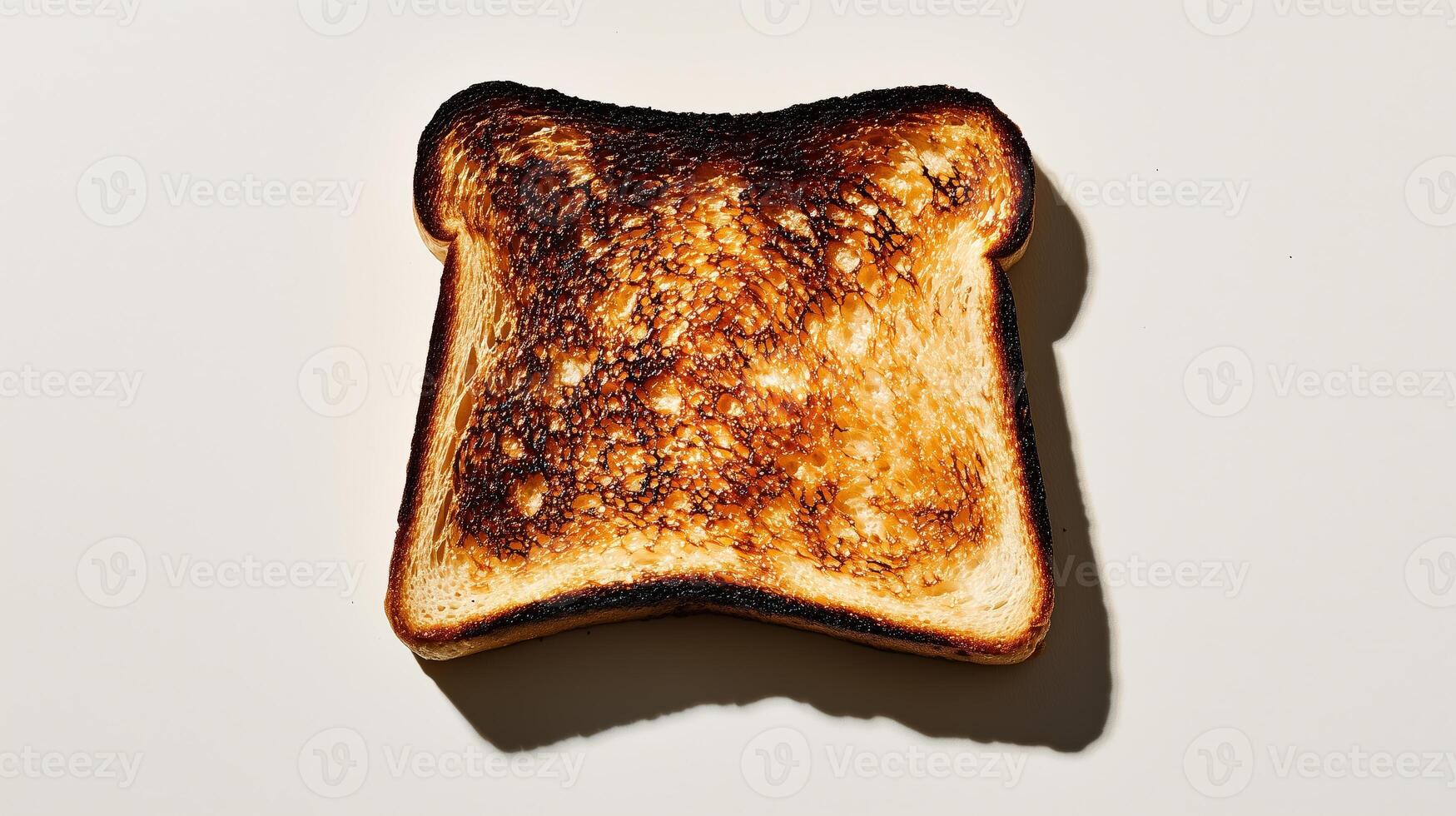 Crunchy golden brown toast with distinct charred patterns on light background photo