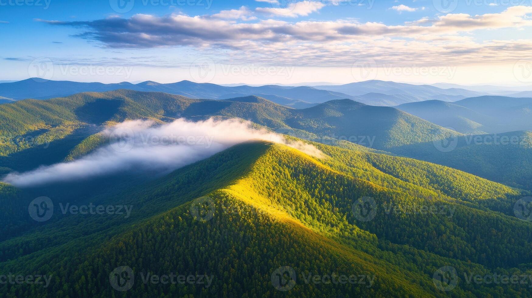 Aerial view of lush green mountain range with rolling hills and clouds photo