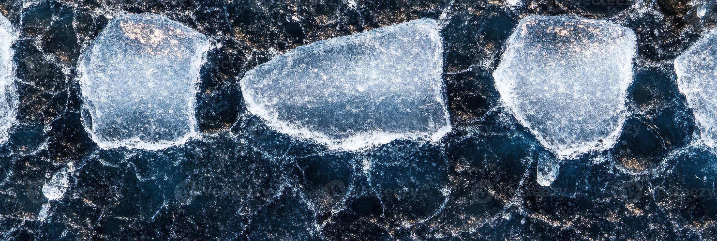 Aerial view of large ice chunks in cold water creating natural patterns photo