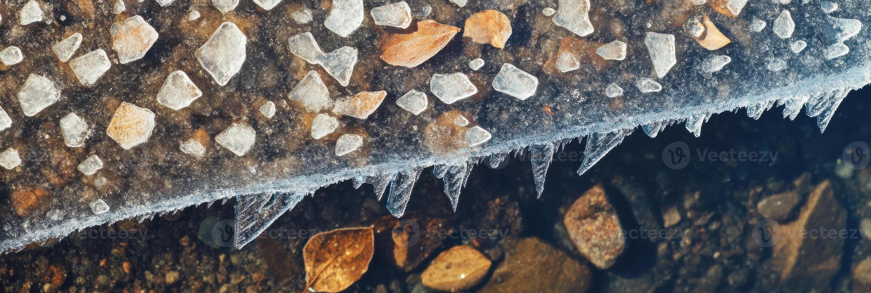 Close-up of ice crystals on rock surface showing winter frozen nature pattern photo