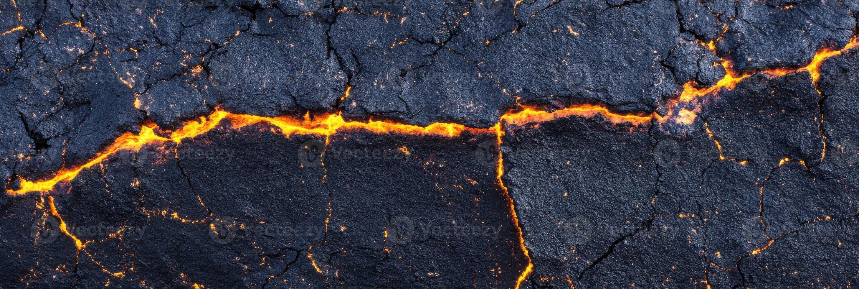 Cracked lava surface with glowing magma lines creating a natural abstract pattern photo