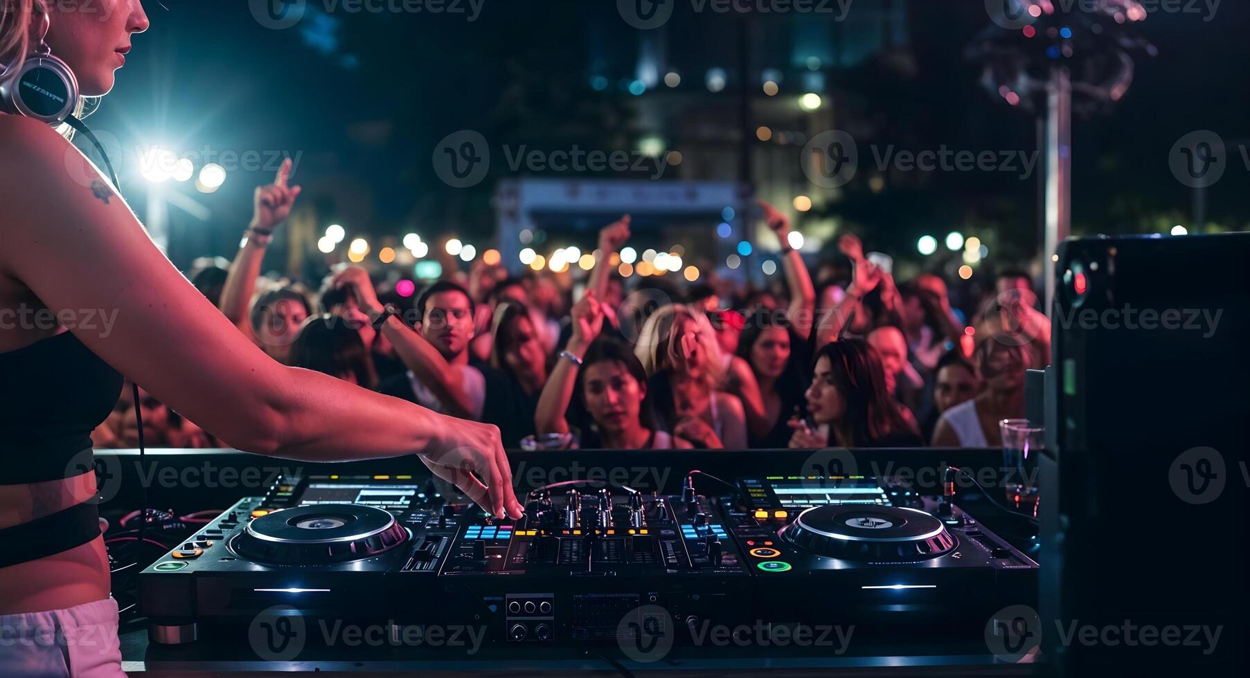 Female DJ Performing Live Music at Outdoor Party for Crowd photo