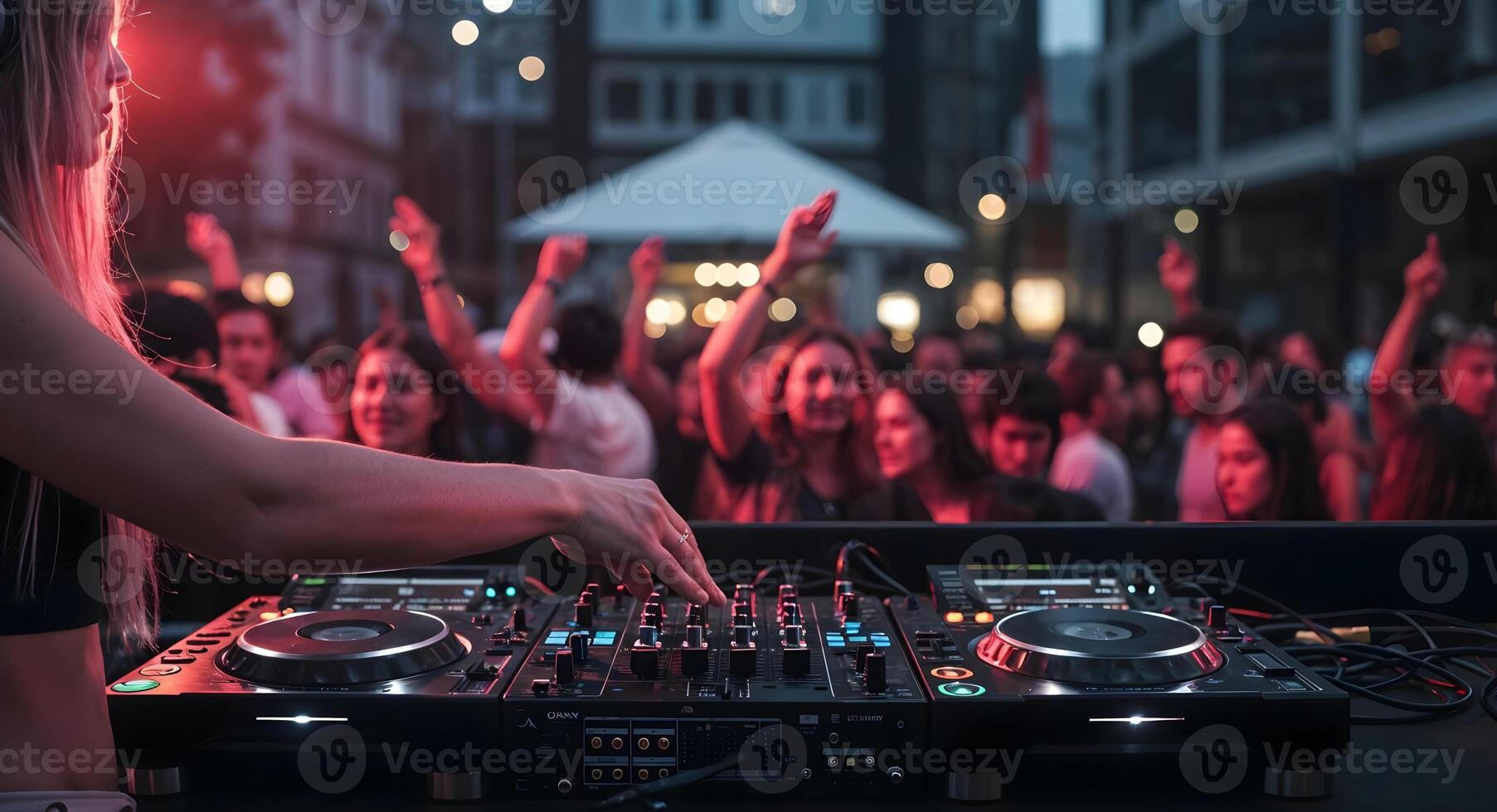Female DJ Mixing Music at Outdoor Party with Crowd Dancing photo