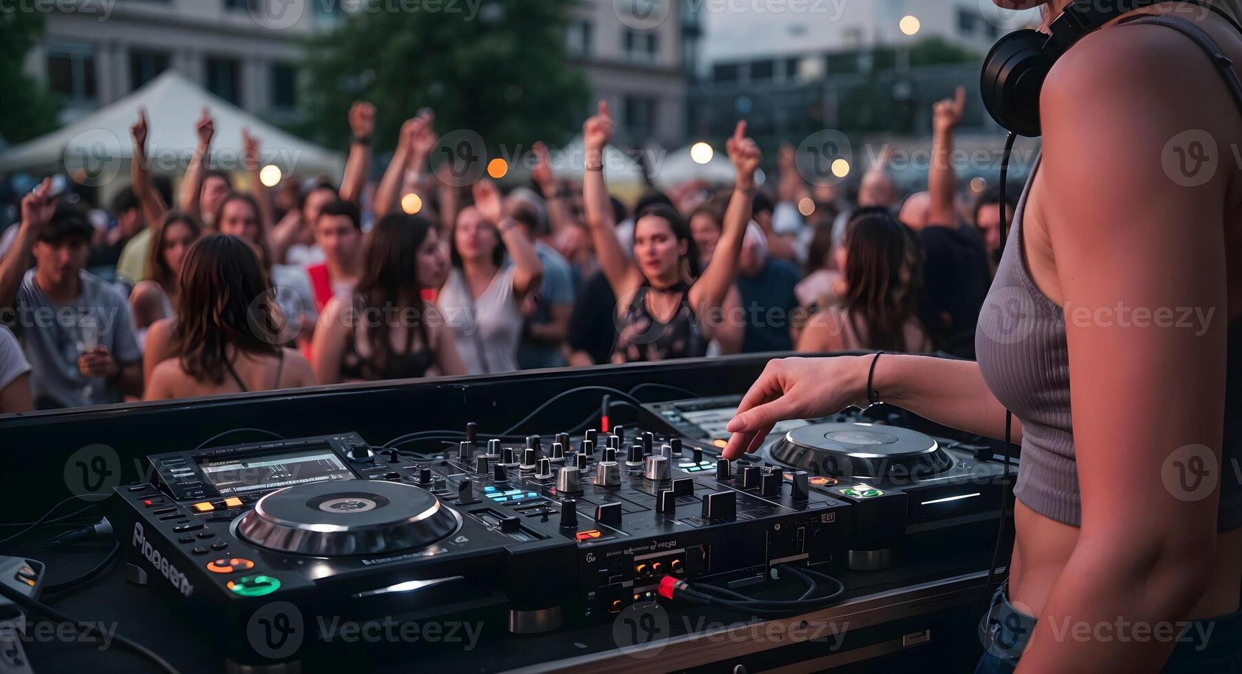 Female DJ Performing at Live Music Event Before Cheering Crowd photo