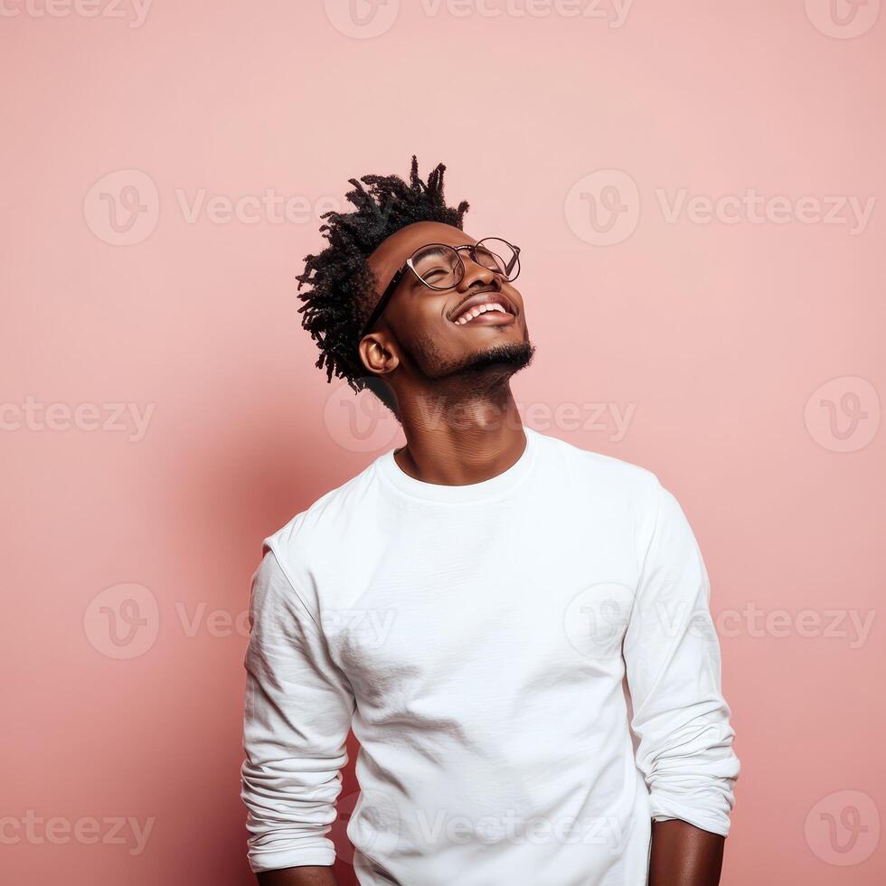A young man with dreadlocks is looking up photo
