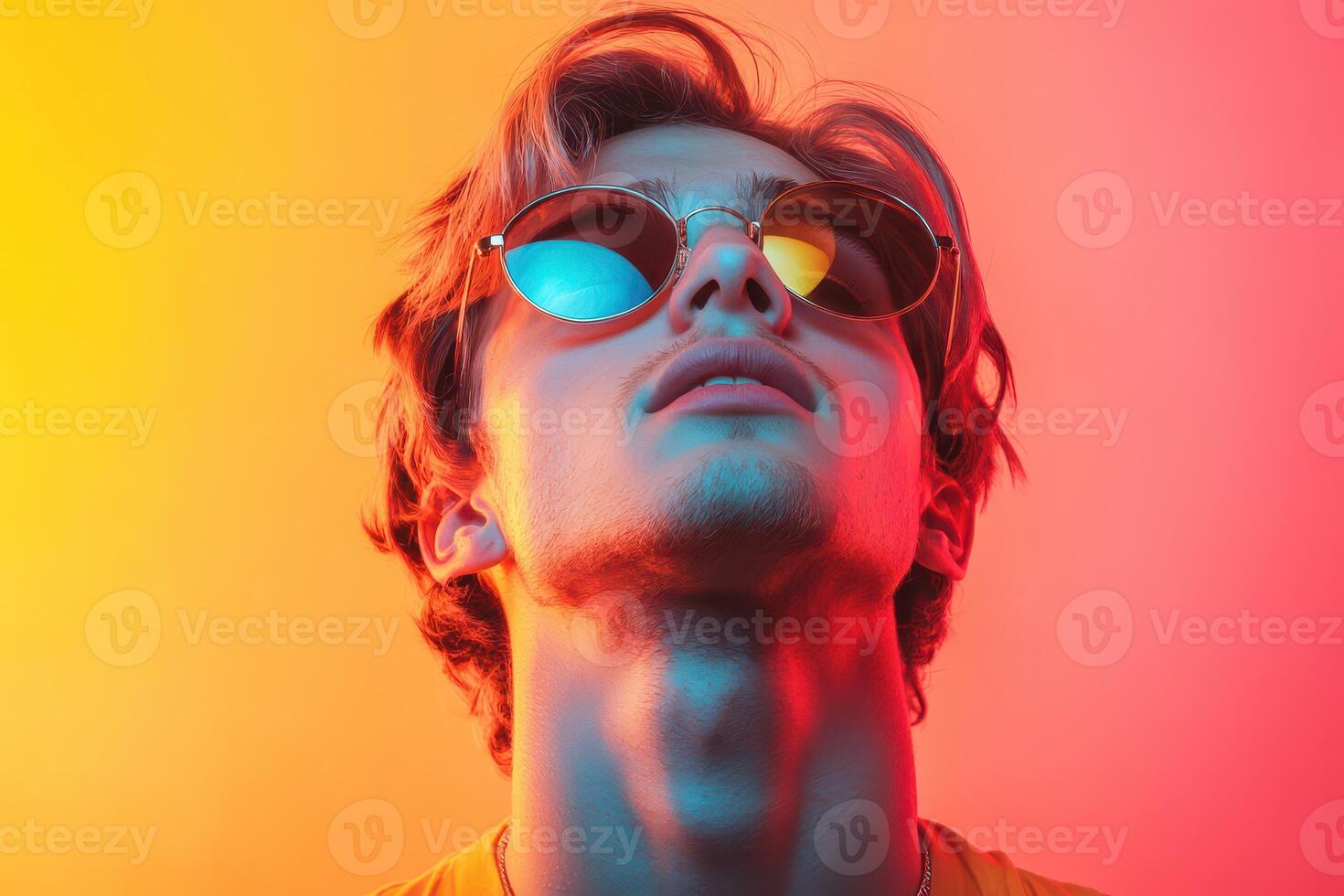 A man wearing sunglasses and looking up photo
