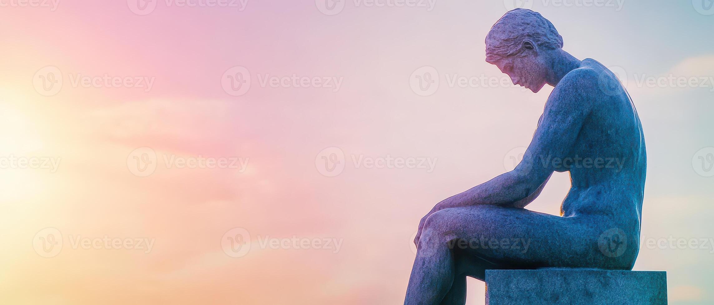 A statue of a woman sitting on a bench photo