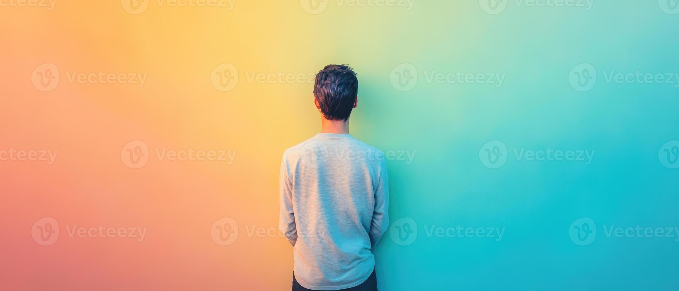 A man standing in front of a colorful wall photo