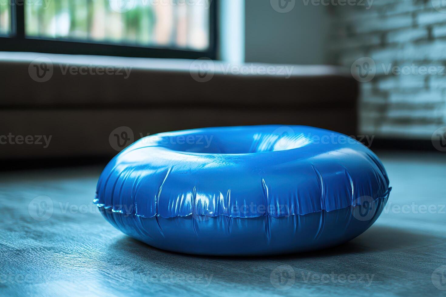 A blue inflatable ball on the floor photo