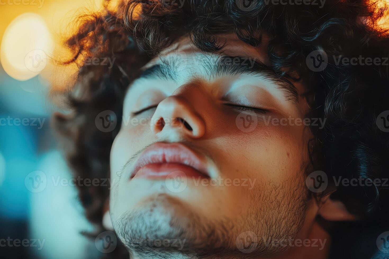 Young man enjoying a calm moment with eyes closed photo