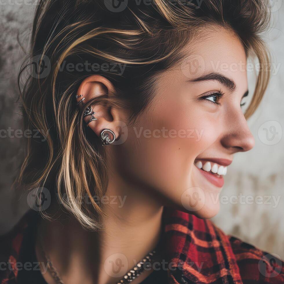 Smiling young woman showcases unique ear jewelry photo