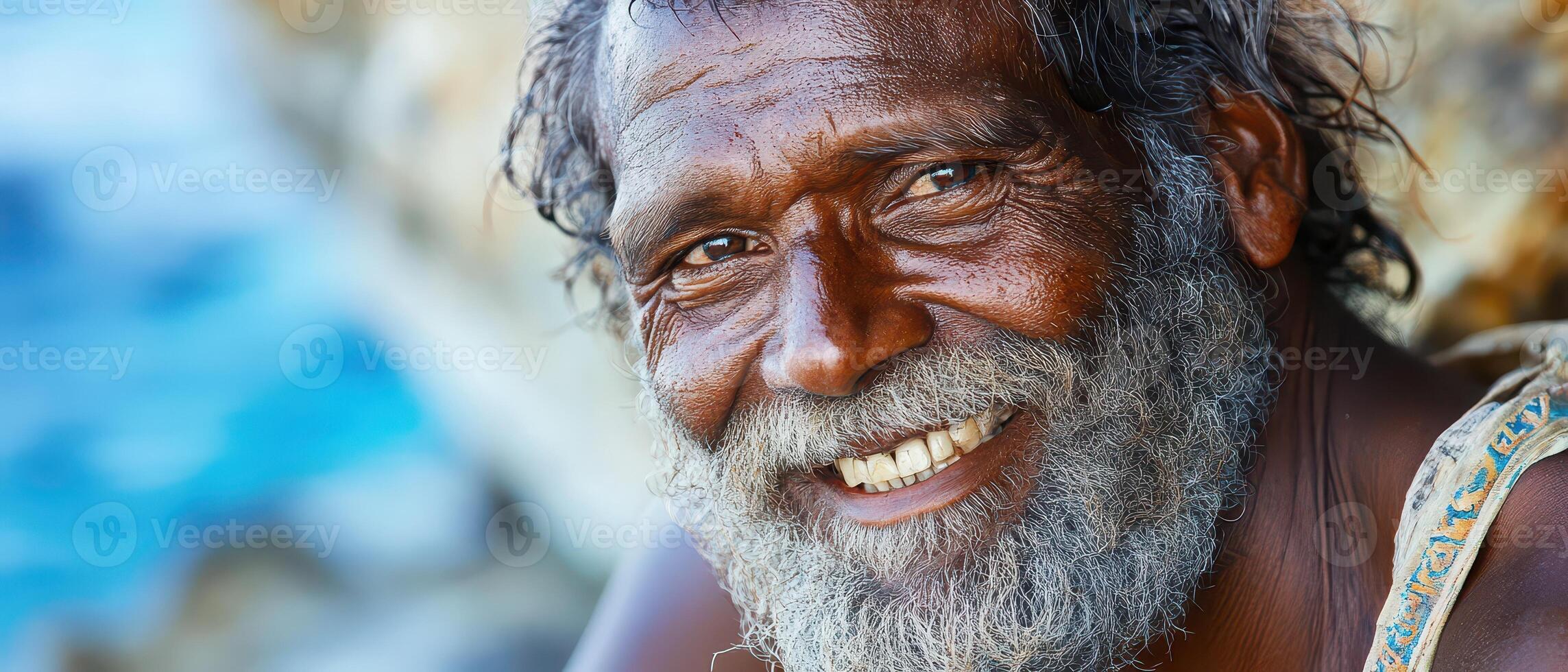 A smiling man with a beard and a smile photo