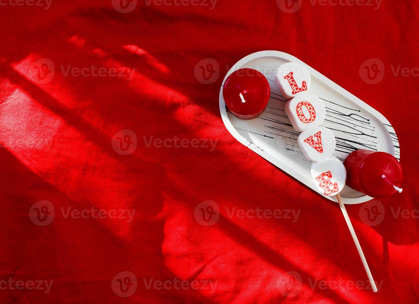 festive background for valentine's day candles on red background photo