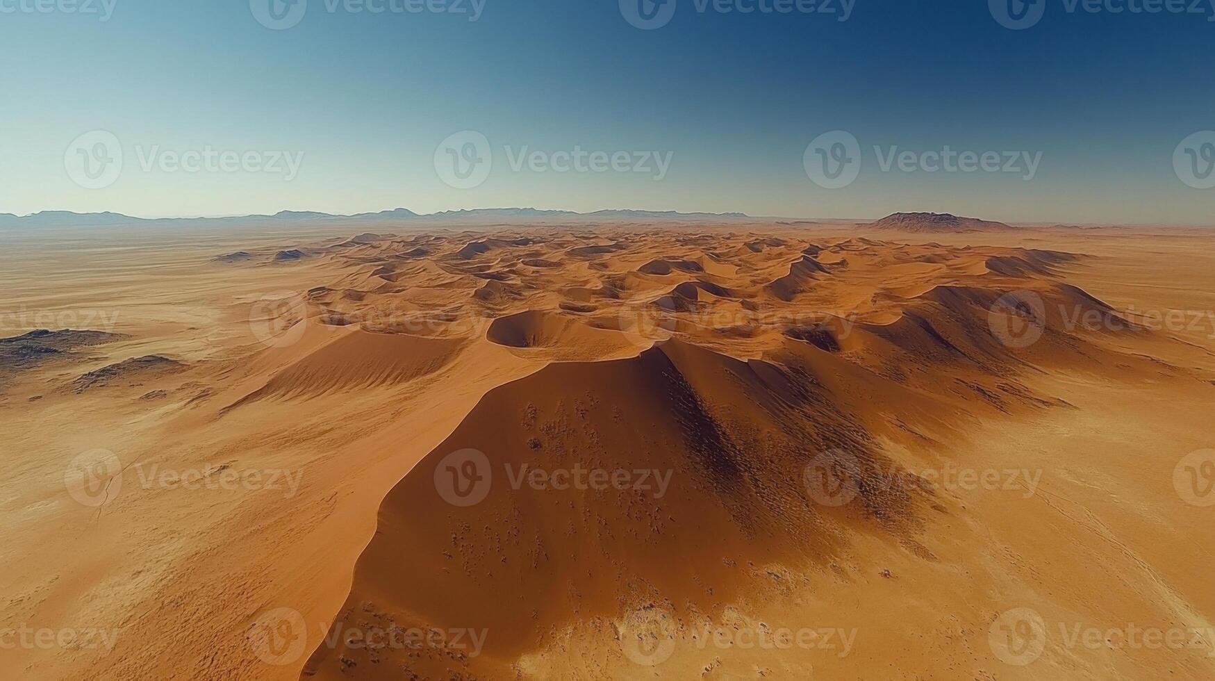 Desert landscape. Sand dunes under clear sky. Aerial view of arid land. Dry and hot climate. Empty place. photo