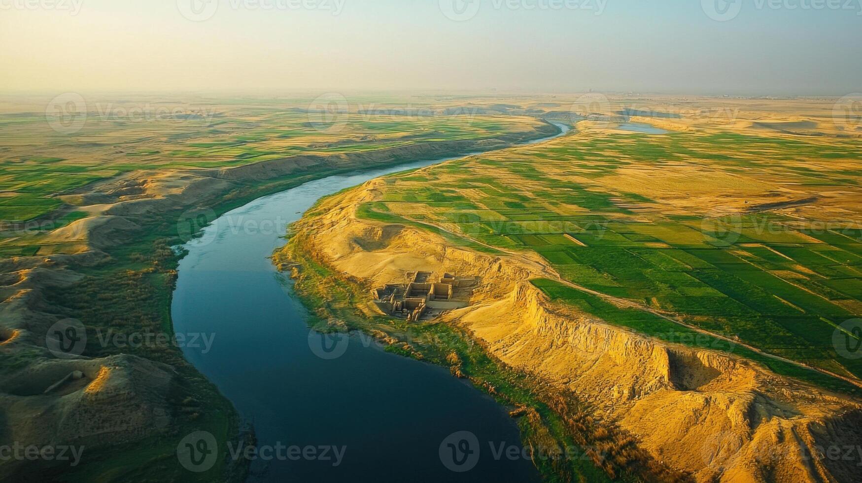 River runs through flat land. Waterway aerial. River winding through fields. Landscape river aerial view. Water flowing from up high. photo