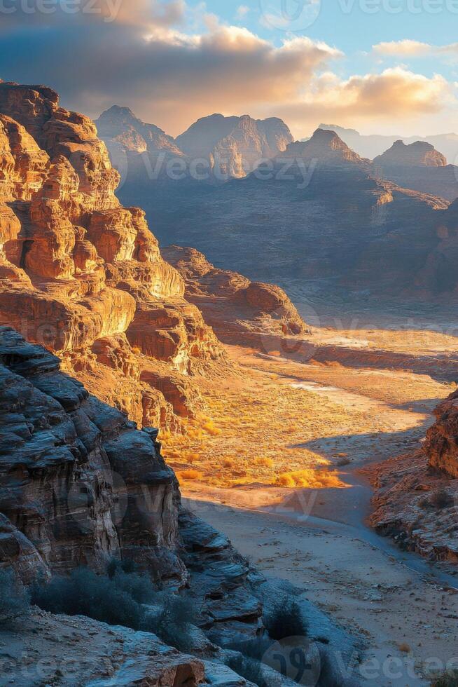 Desert canyon view. Sunlight on rocks and valley. Beautiful nature landscape. Peaceful and calm scene. Mountain range background. Clear sky above. photo