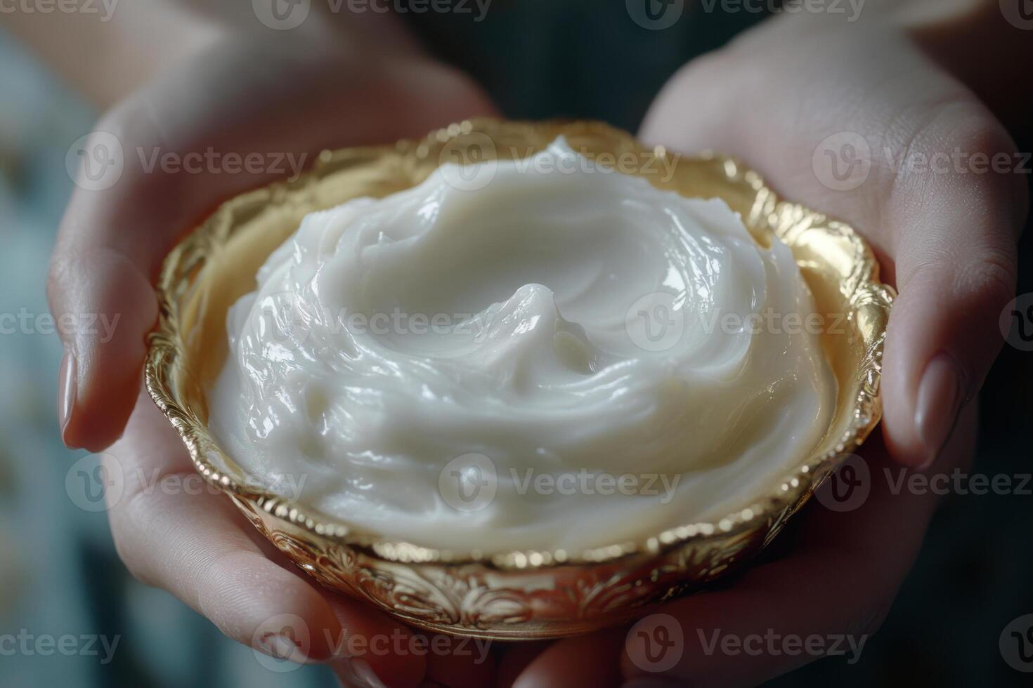 Hands hold bowl. White cream inside. Golden bowl. Skin care. Cosmetic product. Beauty treatment. Woman offering cream. Shiny texture. Moisturizing effect. Soft lotion. Nourishing formula. photo