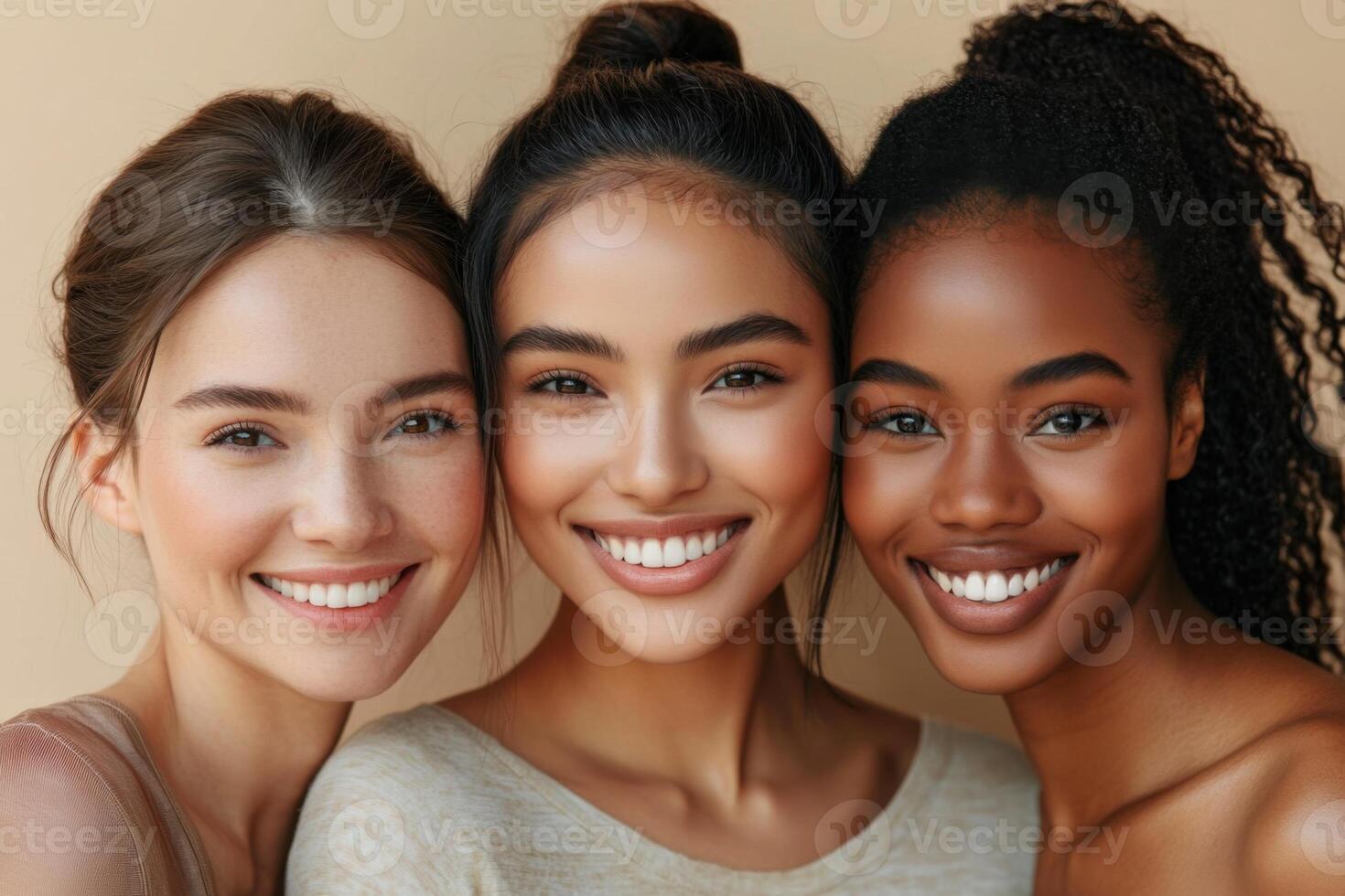 Three diverse young women smiling together. They are standing close. Their skin is clear. The background is a neutral beige color. Beauty concept. photo