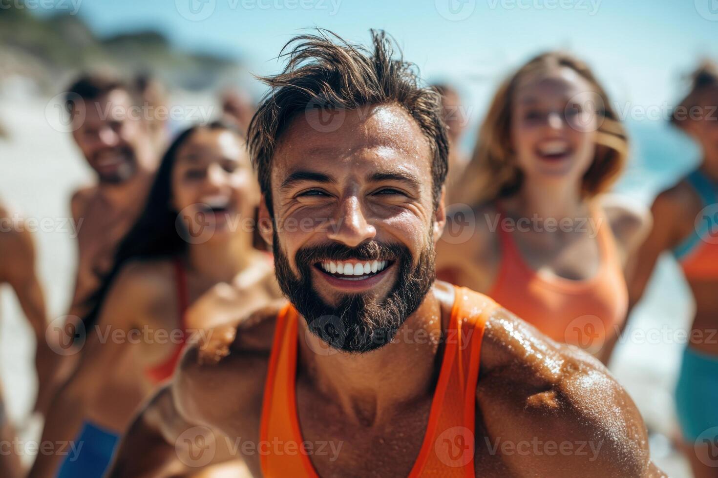 Smiling man with group on beach. People laugh in sunlight near ocean. Happy friends enjoy summer together. Fun day at seaside for many people. photo