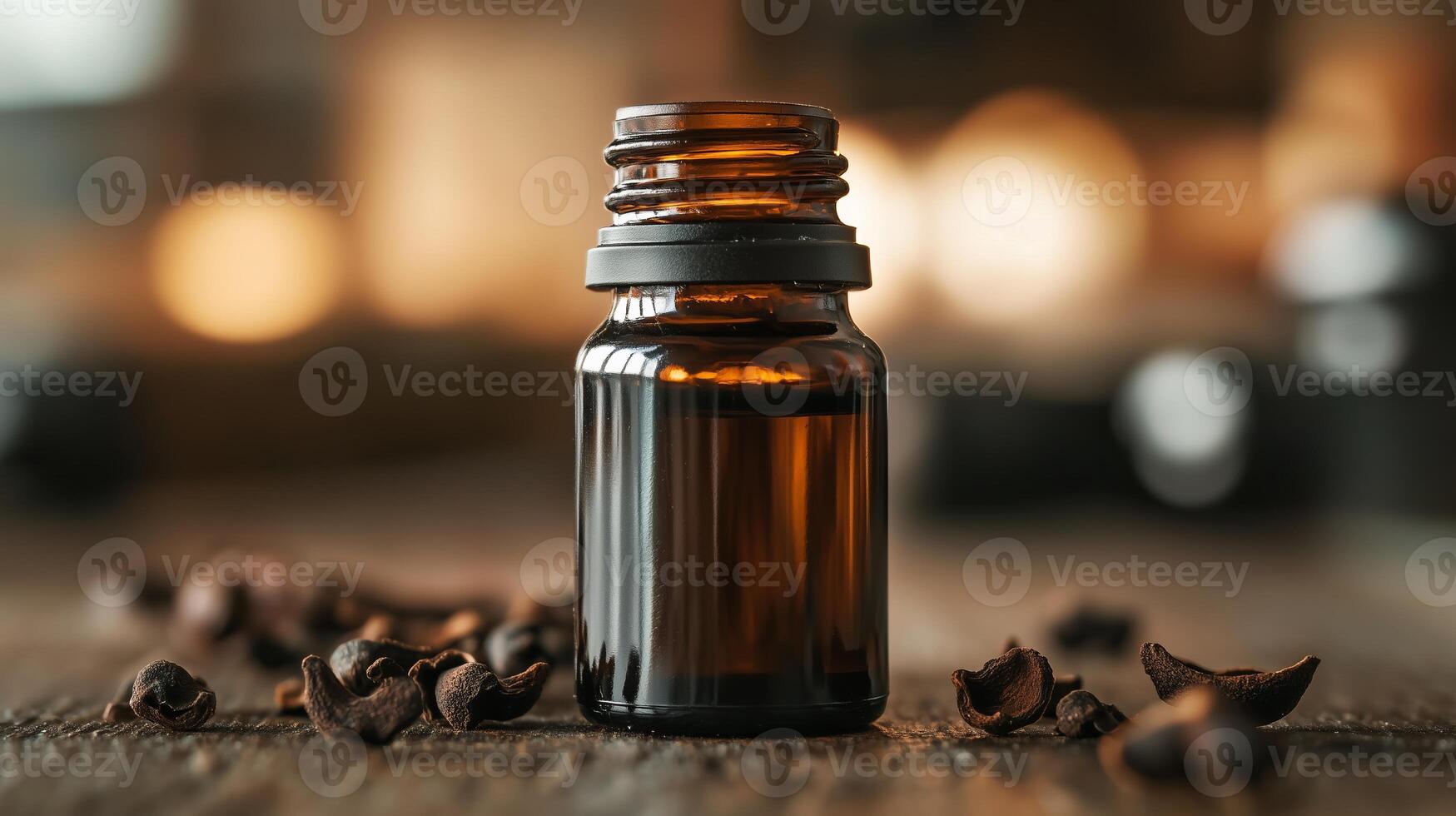 A bottle of essential oil on a wooden table photo
