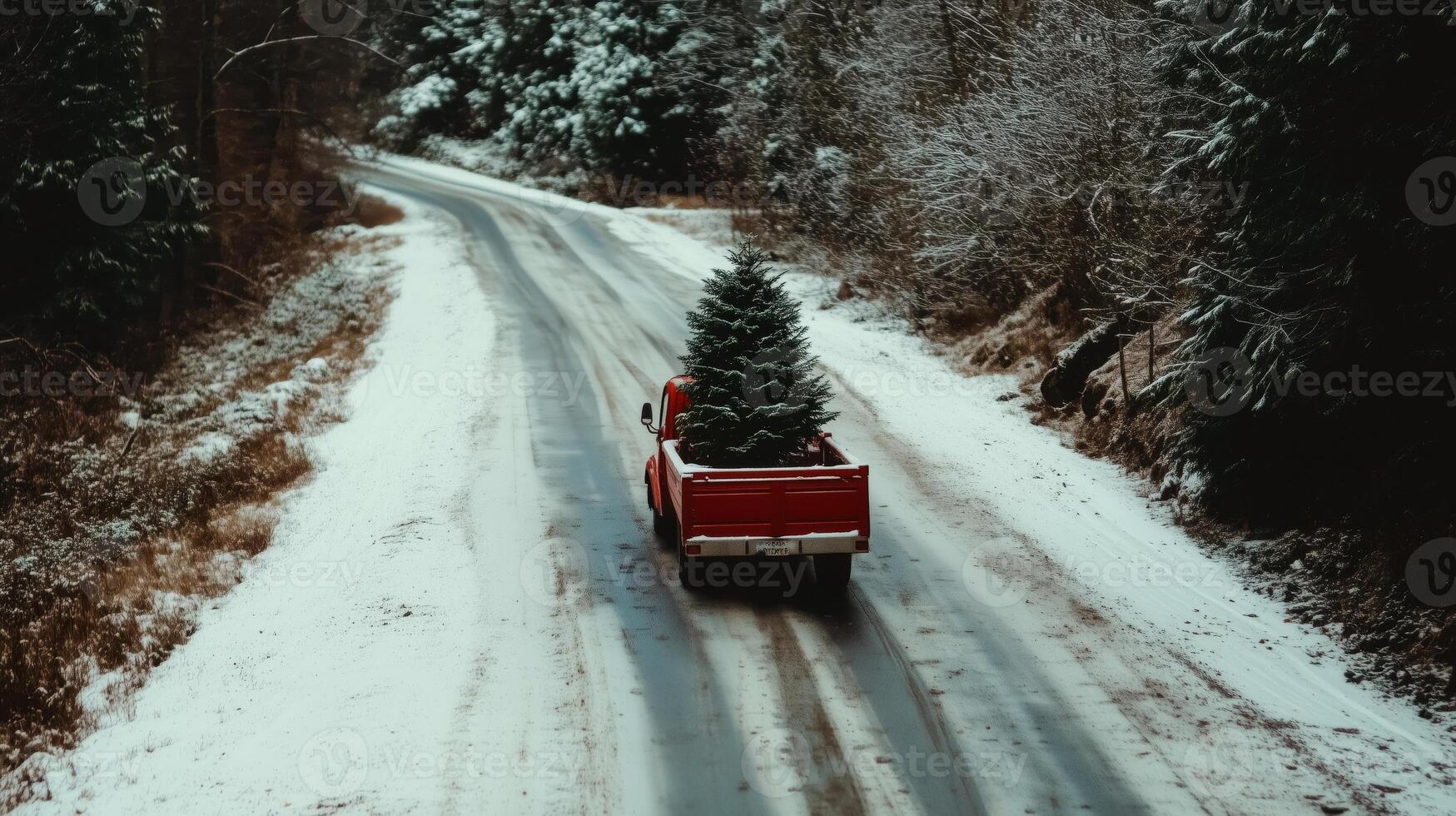 A red truck carrying a christmas tree down a snowy road photo