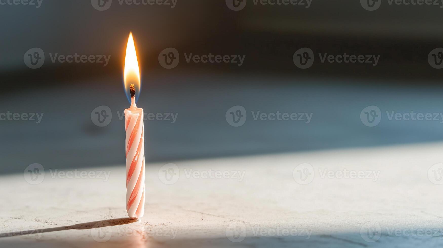 A single lit candle on a table photo