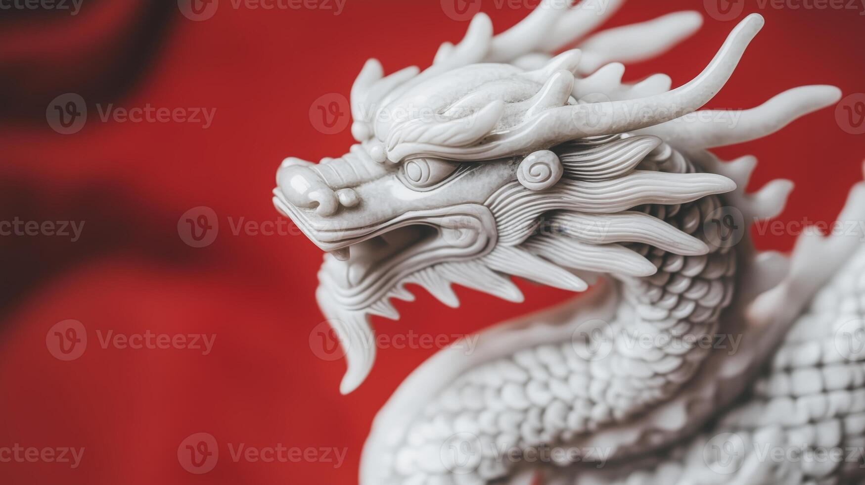 A white dragon statue on a red background. photo