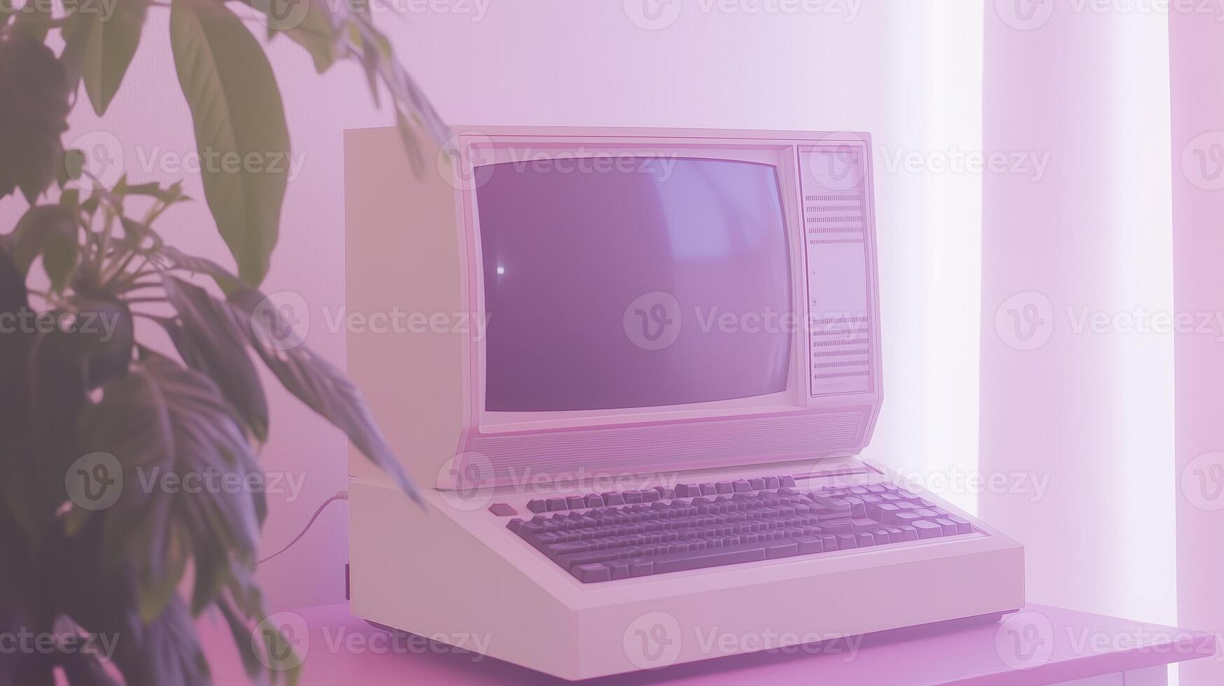 An old computer sitting on a table next to a plant photo