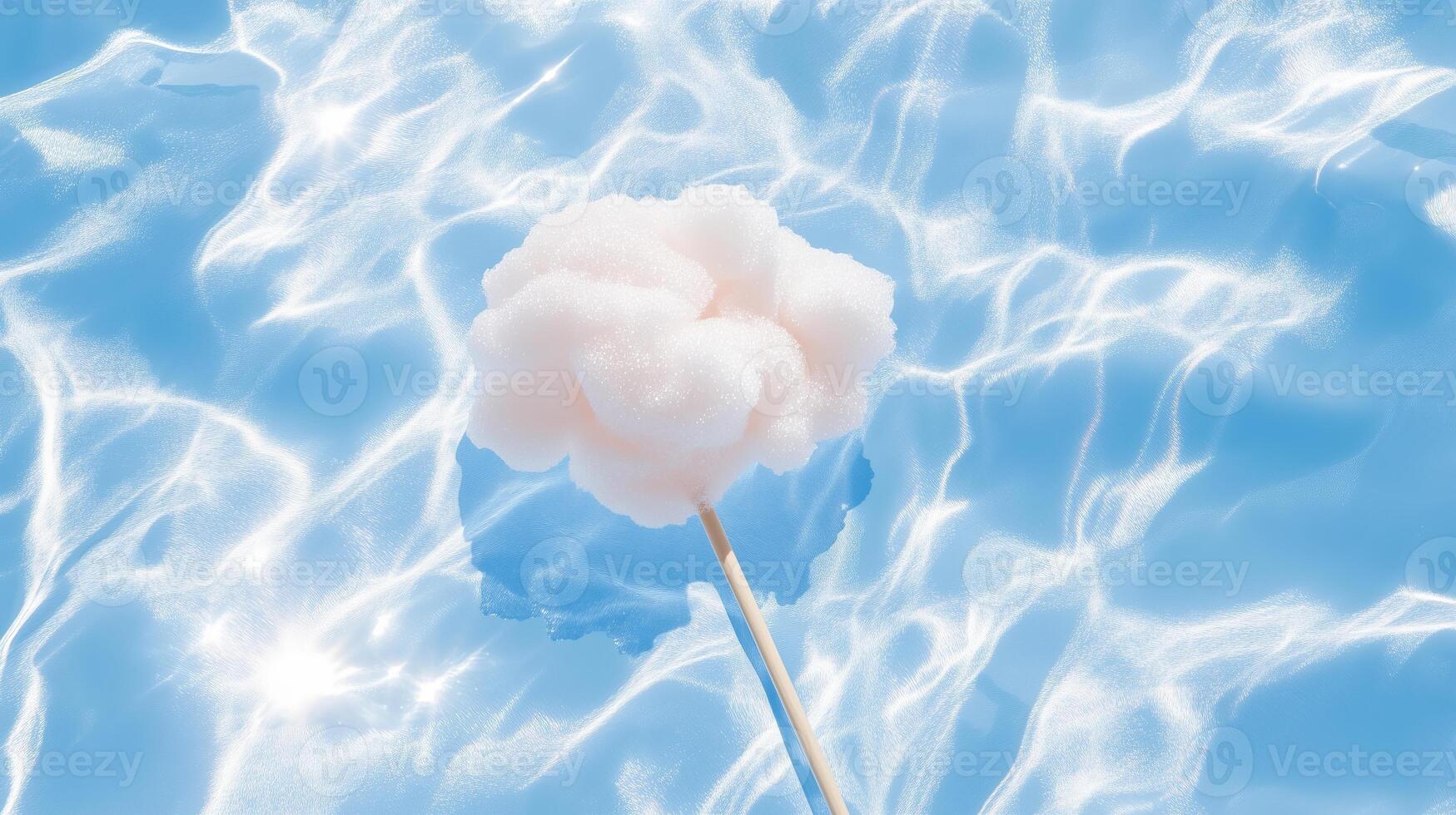 A cotton ball floating in the water with a stick photo