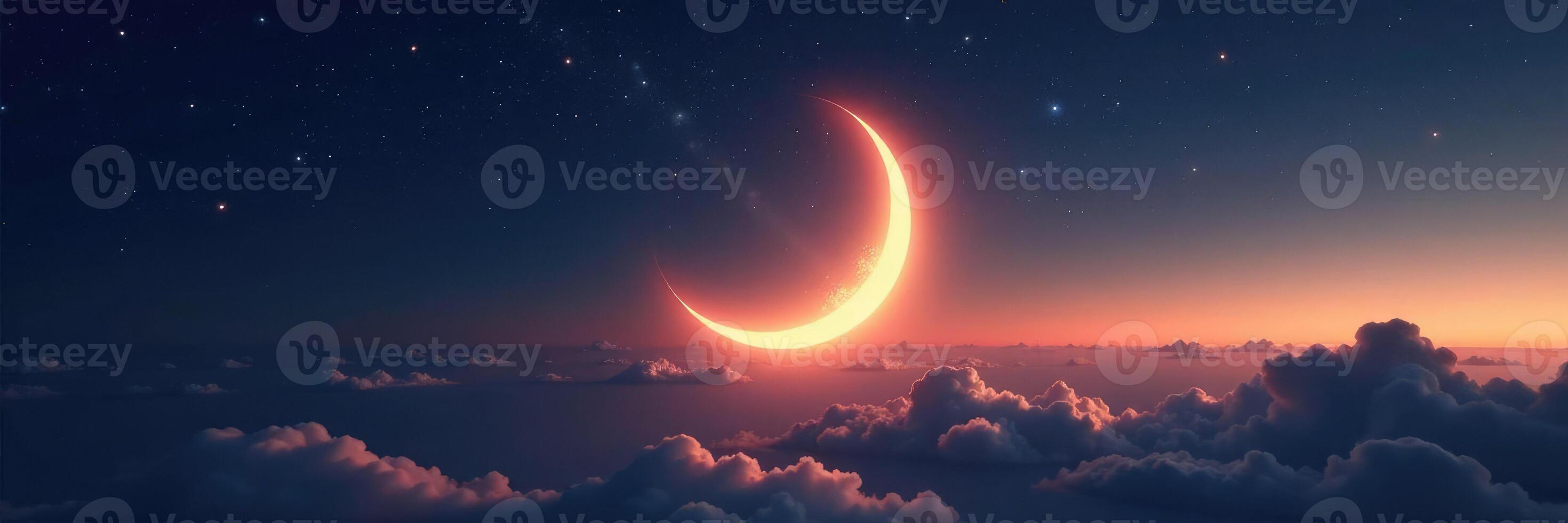 A crescent moon is seen in the sky above clouds photo
