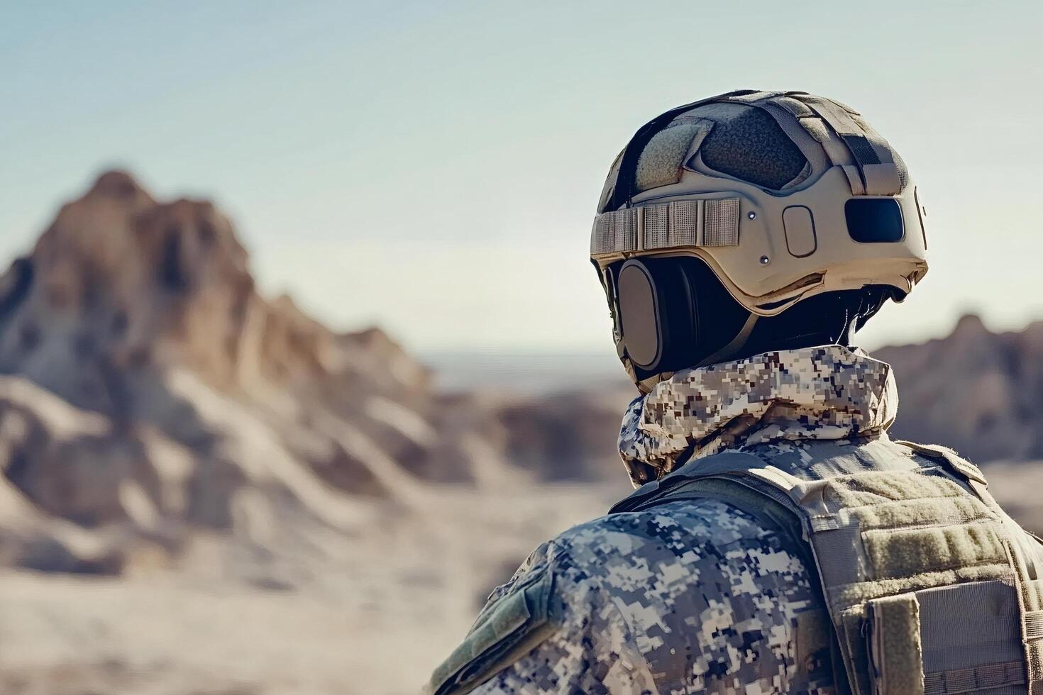 Soldier wearing tactical helmet and camouflage uniform in desert environment photo