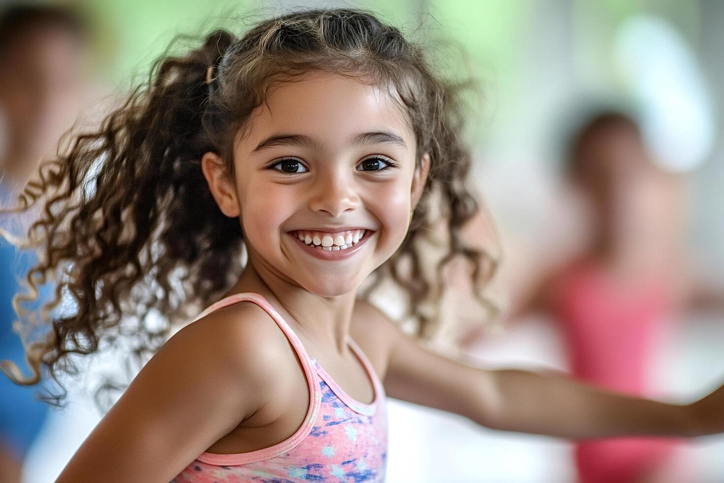 Portrait of smiling girl with curly hair enjoying dance class photo