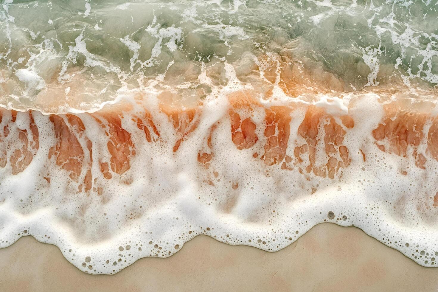 Soft wave gently washing sandy beach creating white foam photo