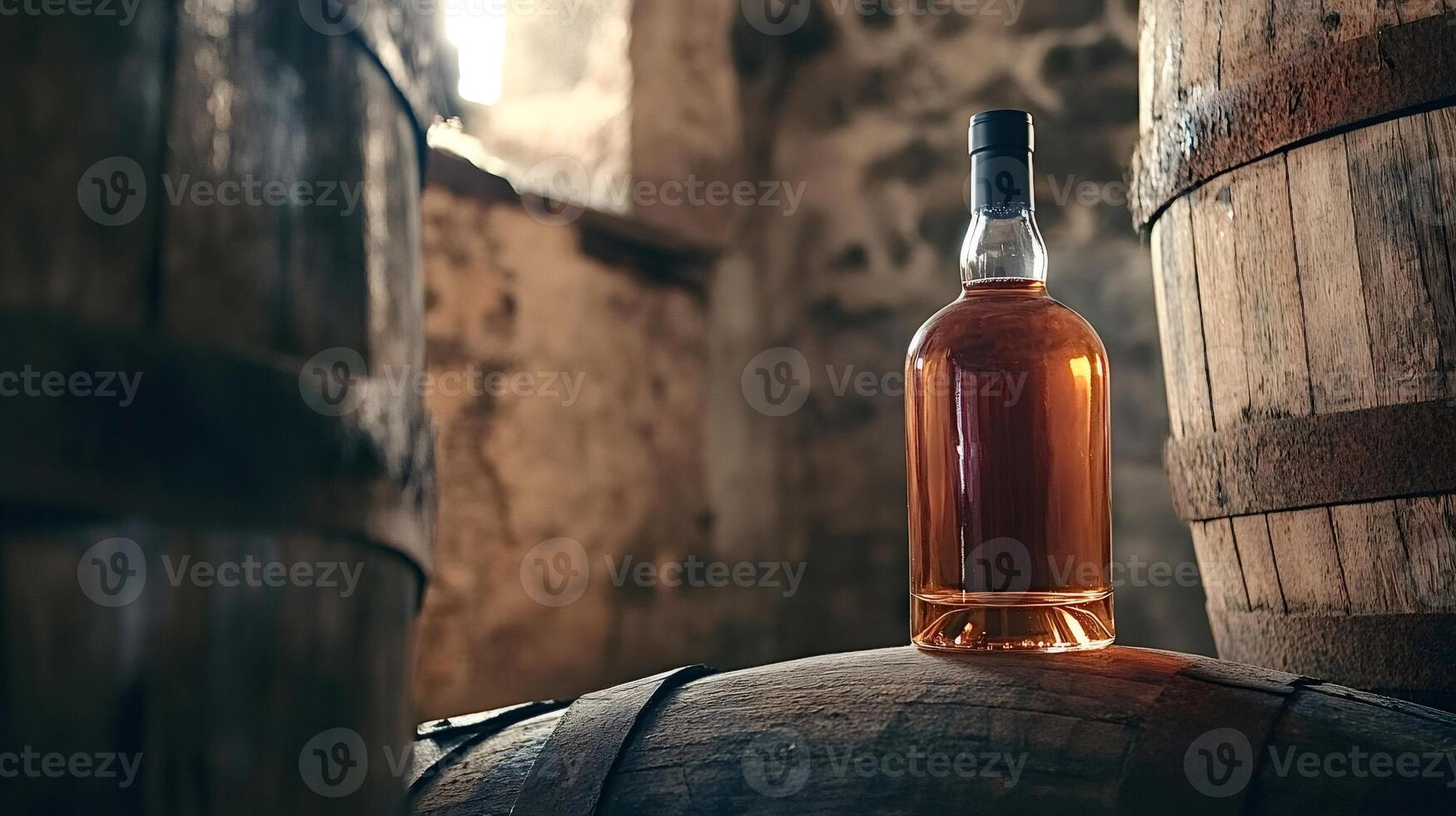 Bottle of whisky resting on oak barrel in cellar photo