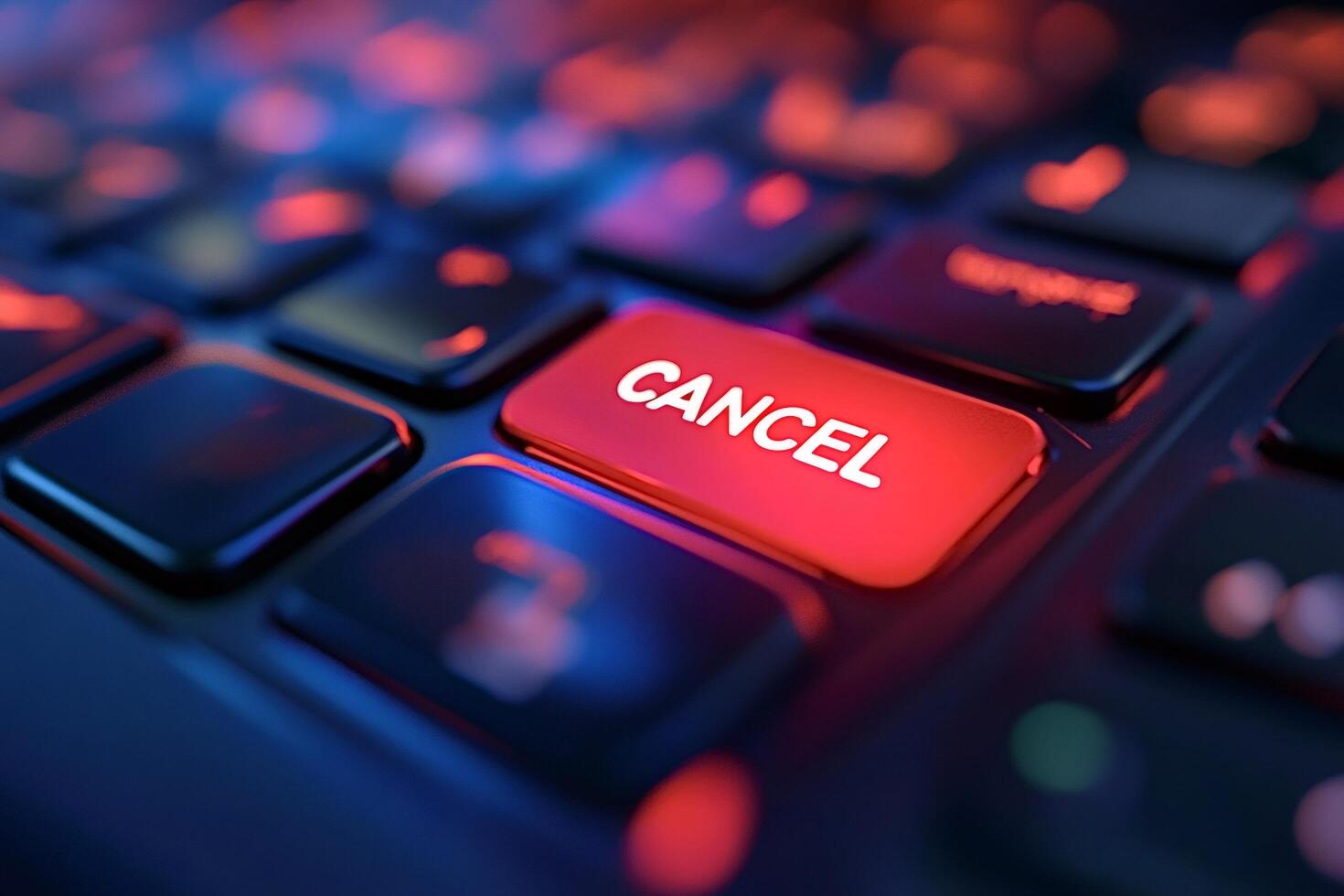 Red cancel key glowing on dark keyboard in close-up photo