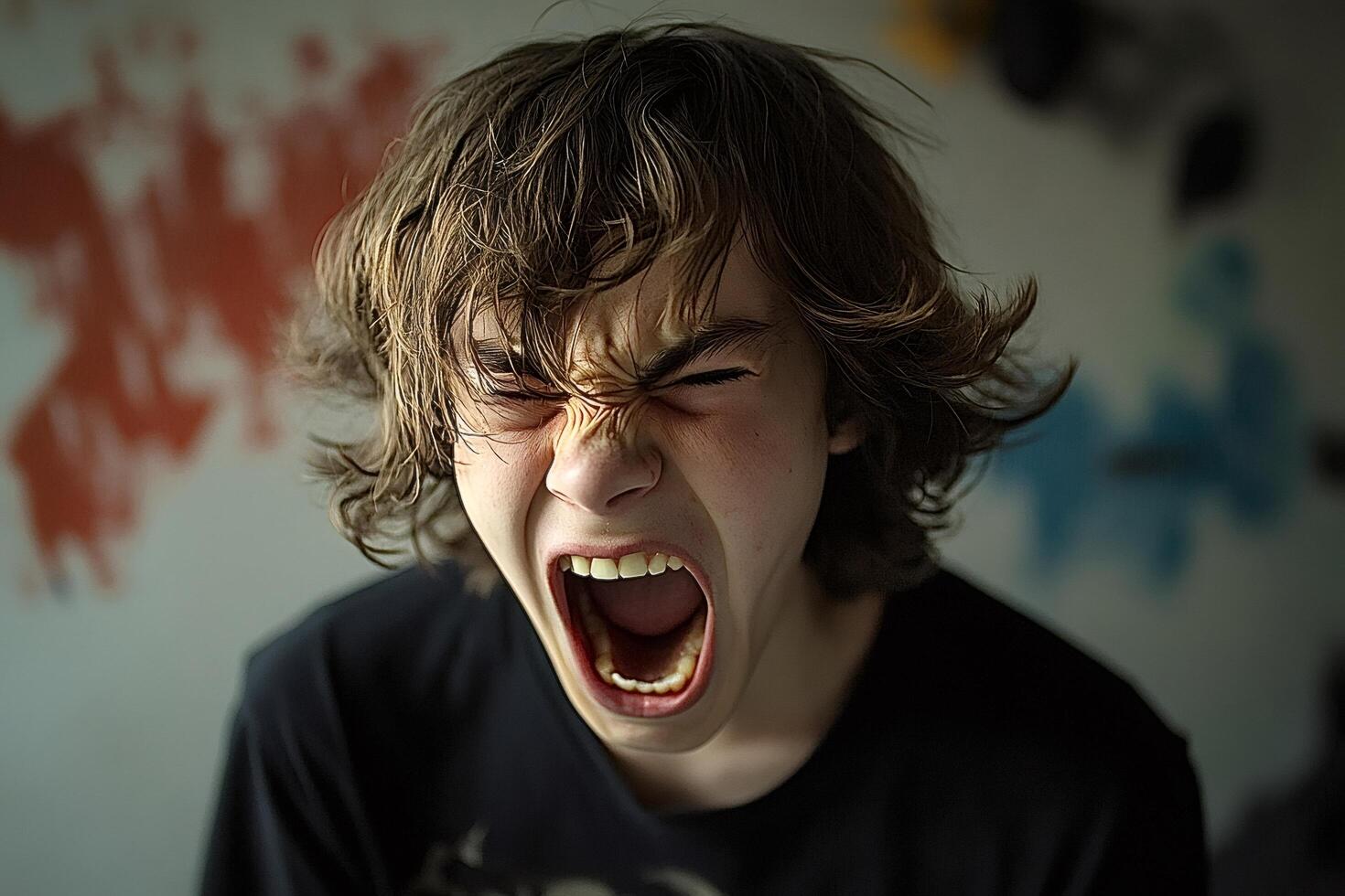 Teenager screaming showing emotions of anger and frustration photo
