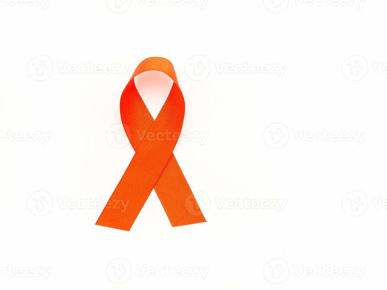 Top view of a red ribbon symbol the fight against HIV, AIDS, and cancer on a white background photo