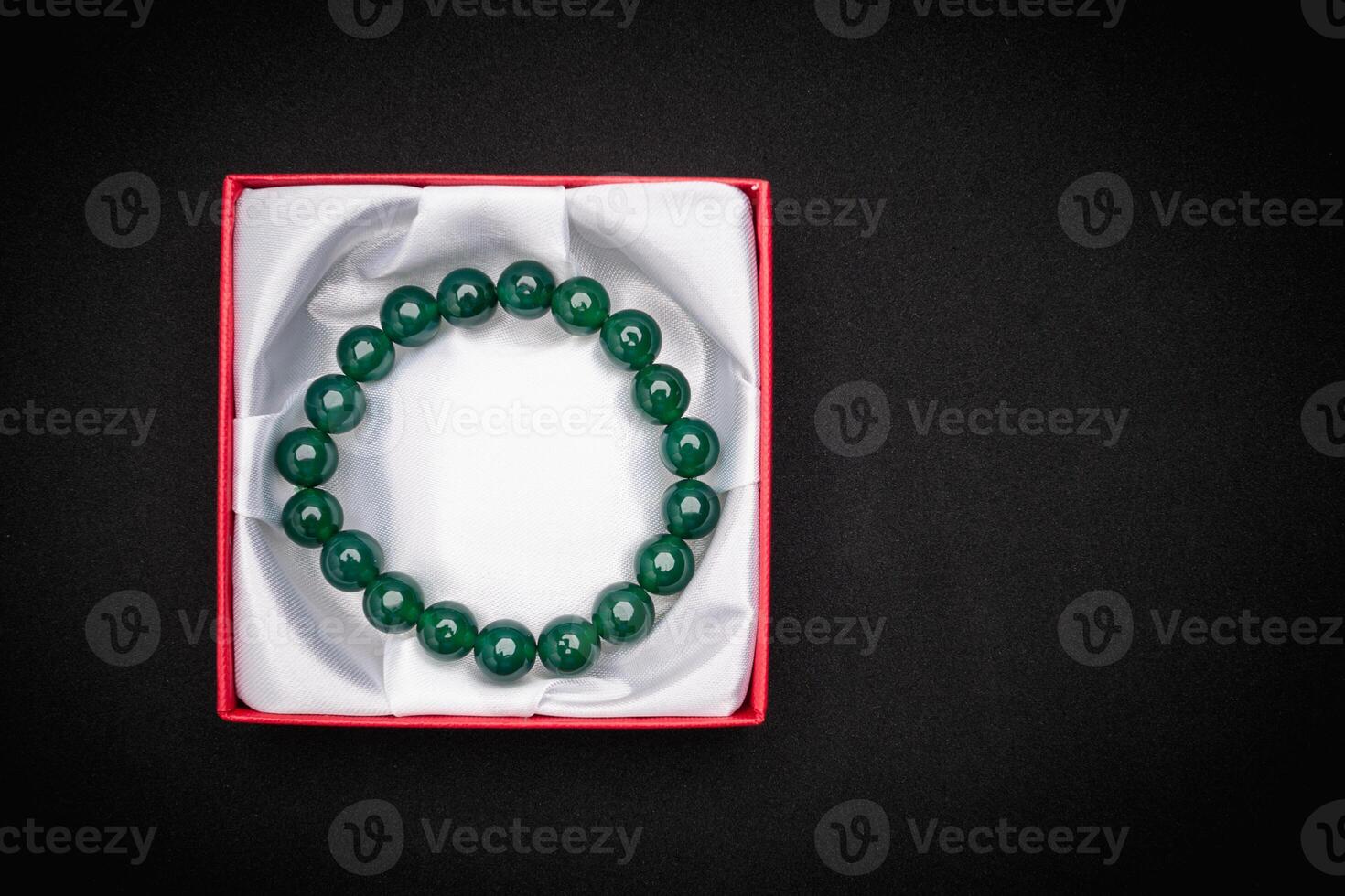 Jade bangle or bracelet in a red box on a black background photo