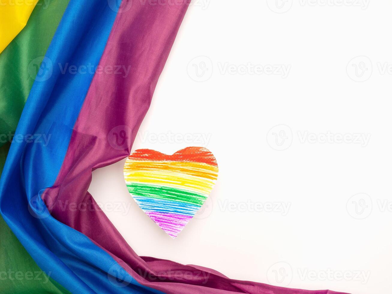 A rainbow flag or LGBT flag and a heart shape symbol on a white background photo