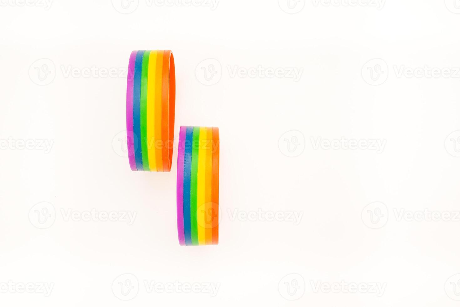 Close-up of two rainbow patterned wristbands are on a white background photo