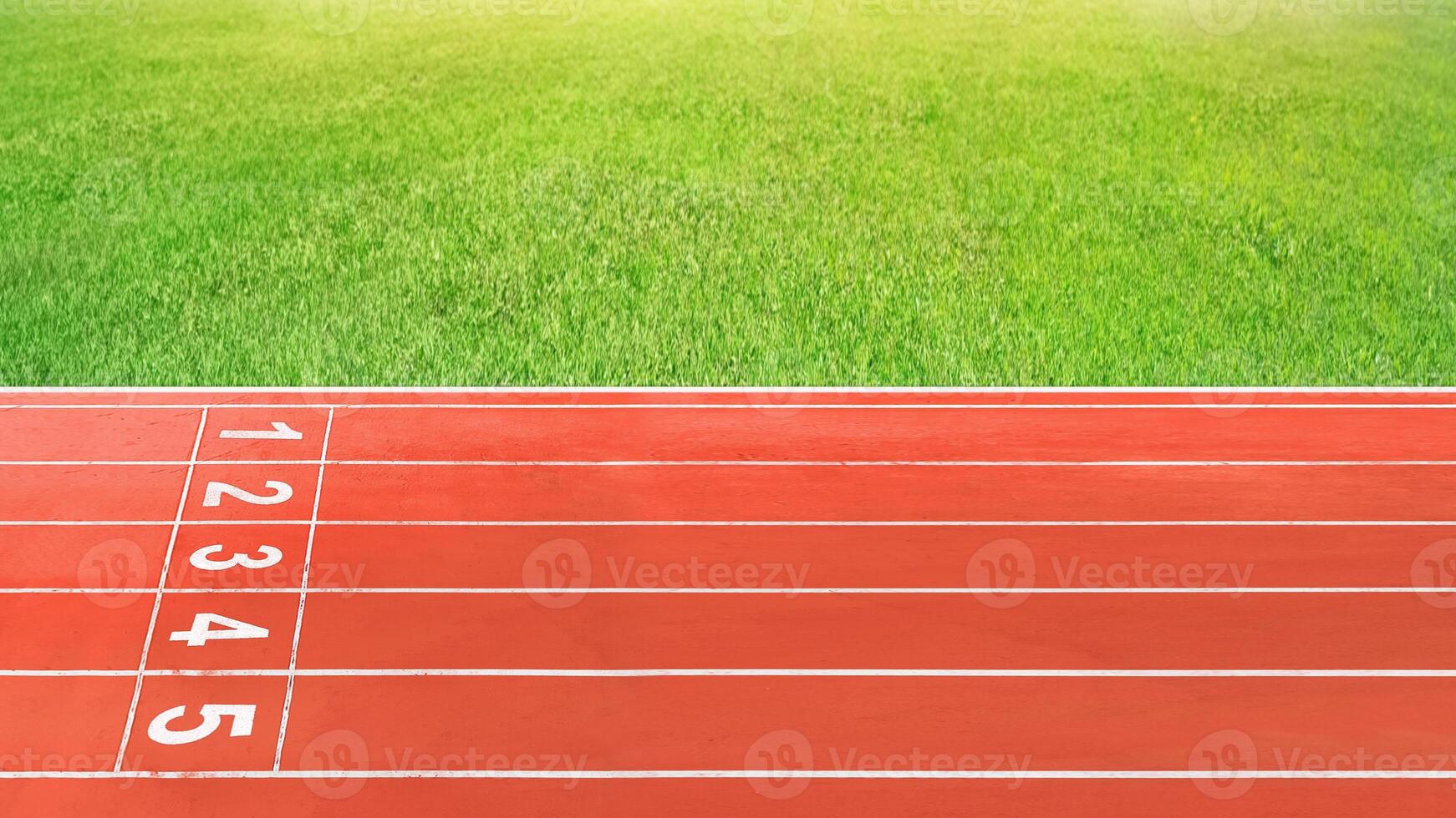 The running track in the red stadium is empty. photo