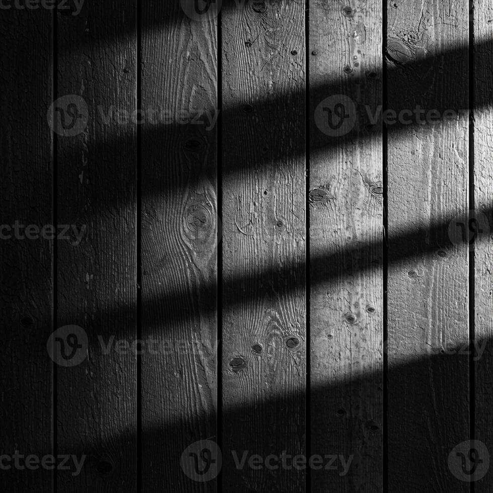 Black and white photo of wooden wall with shadows
