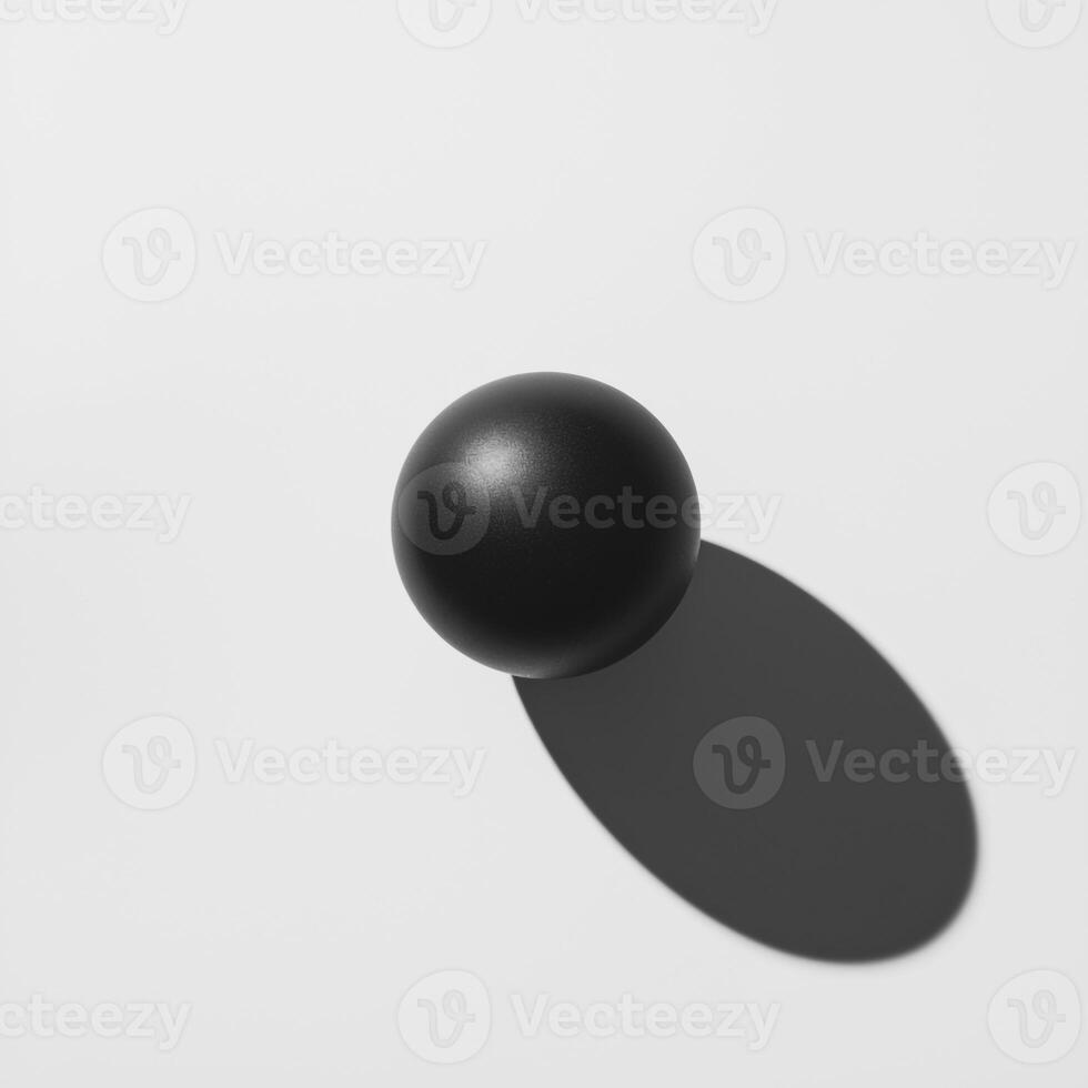 A black ball on a white surface with shadow photo