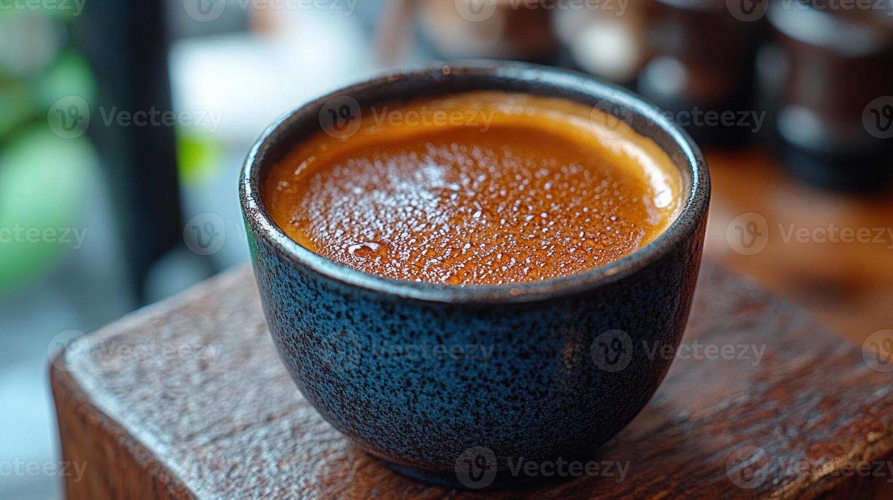 A close-up of a rich coffee in a textured cup. photo