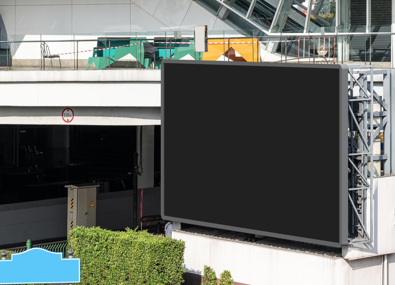 Mock up black screen LED display billboard at crossroad. Clipping path for mockup photo