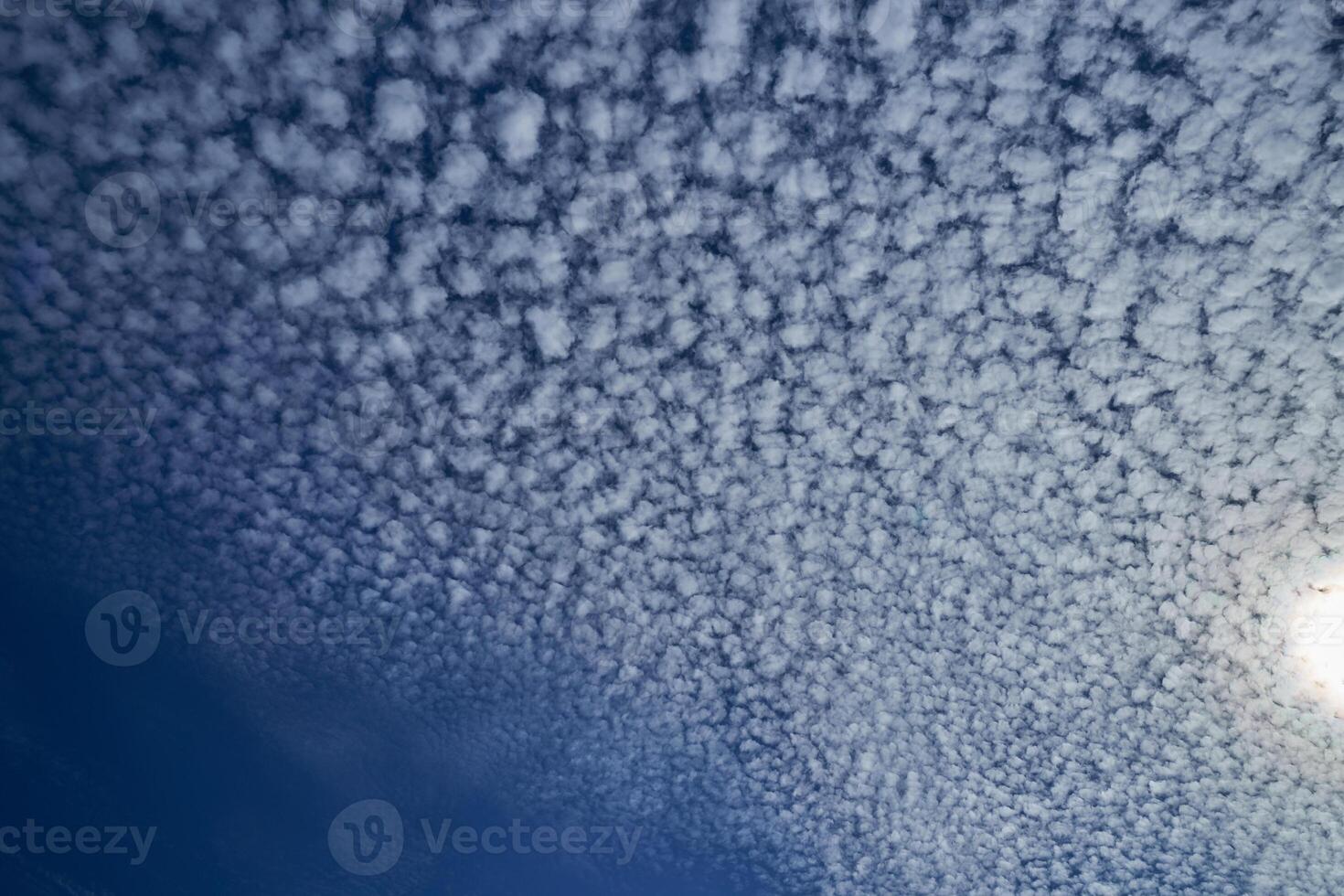 Sun shining through the puffy clouds. Sky view. Beautiful sunny sky. Background with clouds on blue sky. Clouds on blue sky. photo