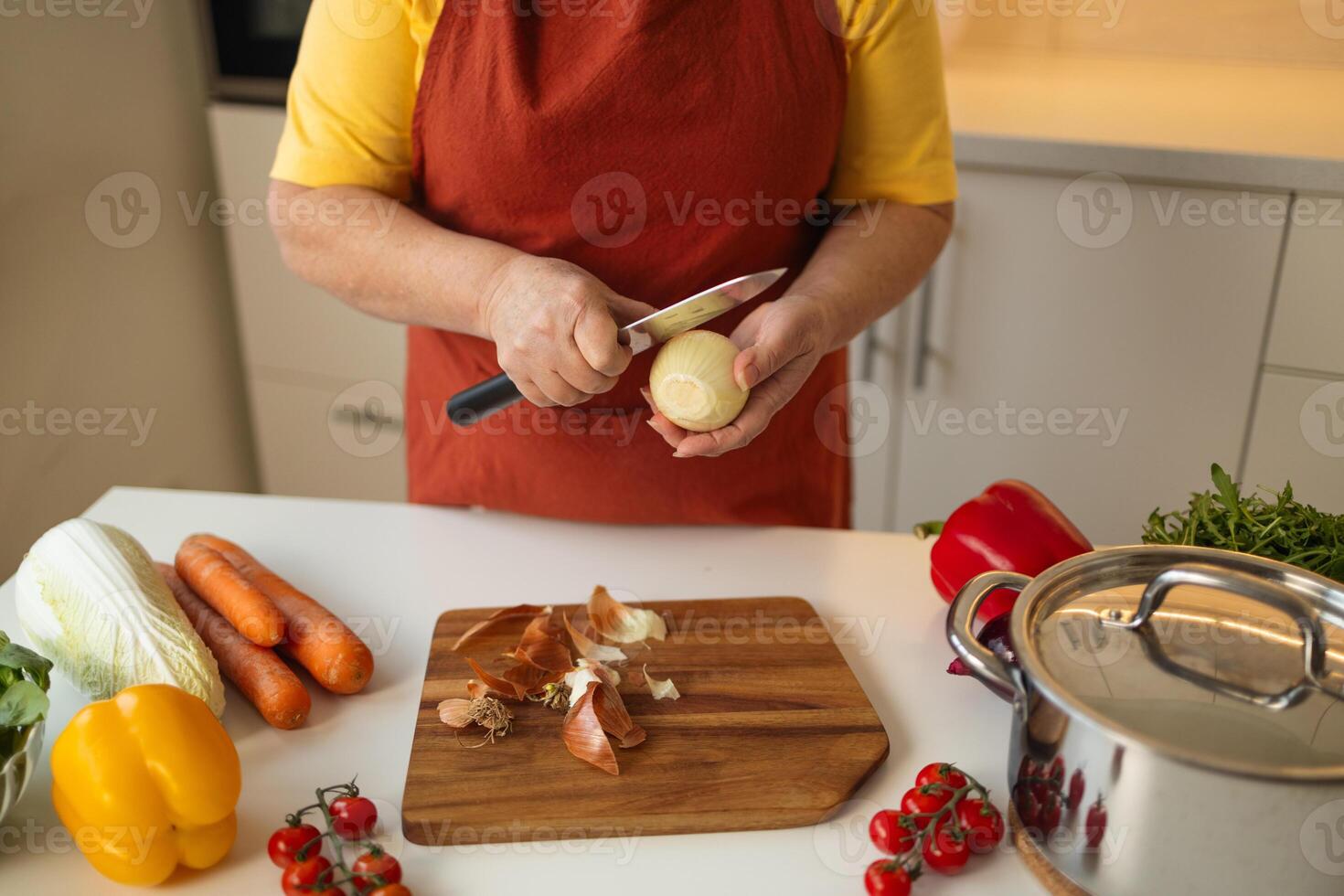Peeling onion in kitchen for meal preparation. photo